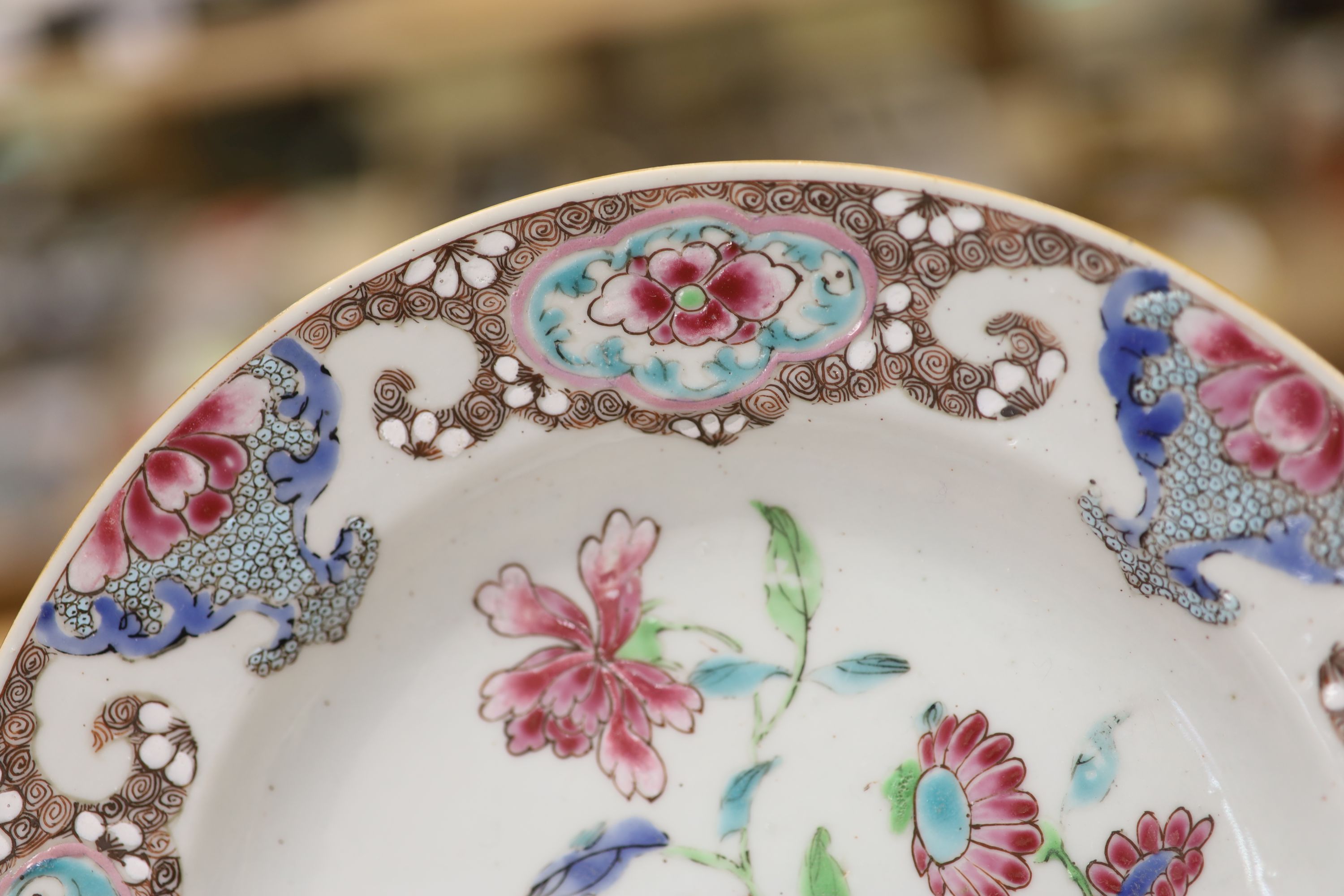 A pair of 18th century Chinese famille rose plates and another similar, largest diameter 22.5cm (damage)